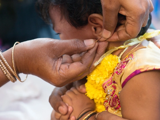 Spacious function hall in Vadavalli for ear boring and piercing ceremonies with modern decor.